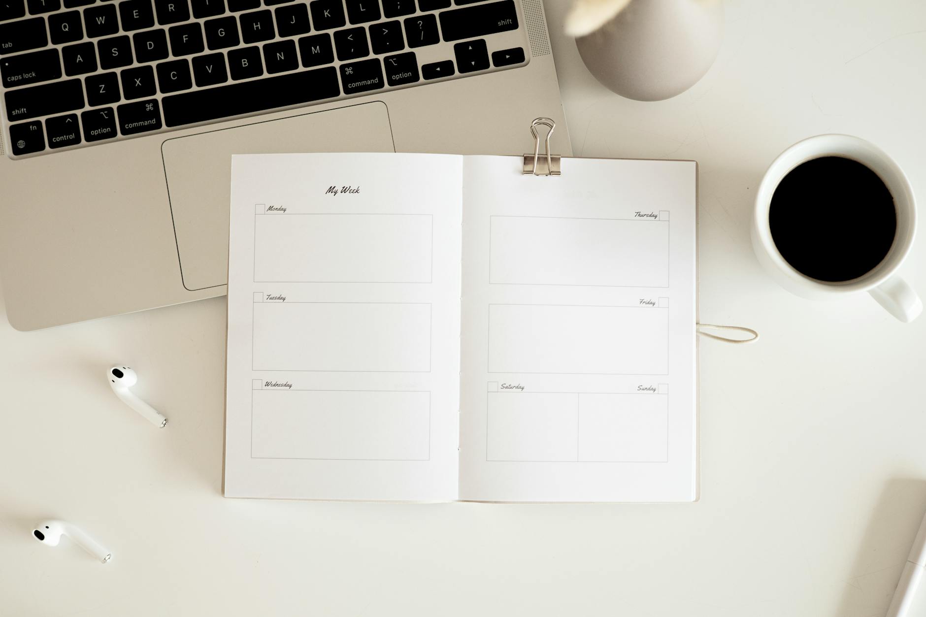 an open notebook planner on white surface